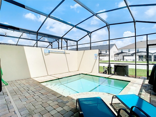 view of swimming pool featuring a patio area and a lanai