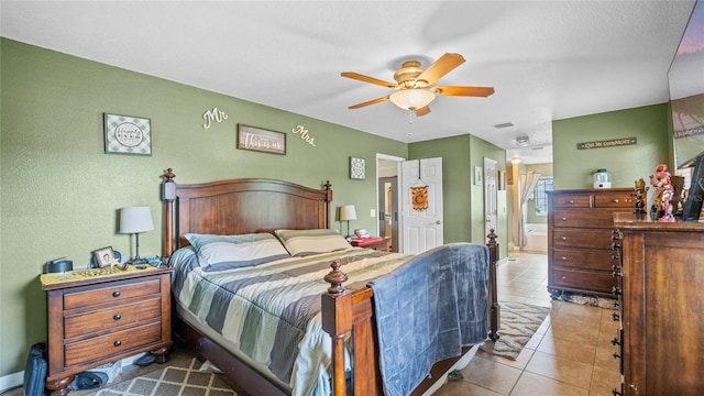 bedroom with ceiling fan and tile patterned flooring