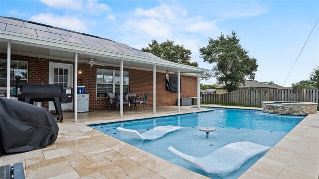 view of swimming pool featuring grilling area, a patio, ceiling fan, and an in ground hot tub