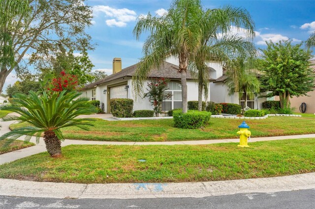 view of front of home with a front yard and a garage