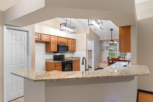 kitchen featuring hanging light fixtures, kitchen peninsula, black electric range, light hardwood / wood-style flooring, and vaulted ceiling