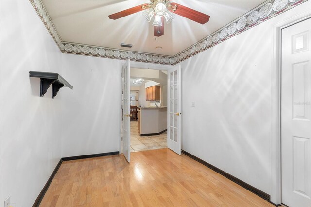 spare room featuring ceiling fan and light hardwood / wood-style floors