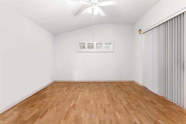 unfurnished room featuring ceiling fan, light hardwood / wood-style floors, and vaulted ceiling