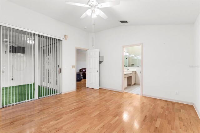 unfurnished bedroom featuring light wood-type flooring, access to exterior, vaulted ceiling, connected bathroom, and ceiling fan