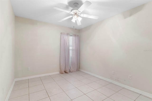 empty room with ceiling fan and light tile patterned flooring