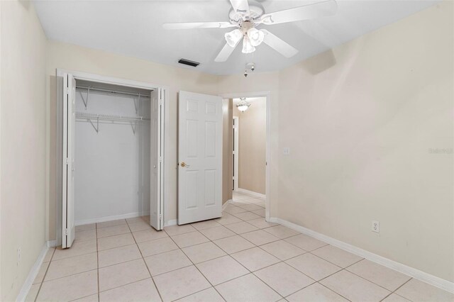 unfurnished bedroom featuring a closet, ceiling fan, and light tile patterned floors