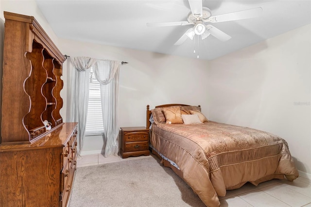 bedroom with ceiling fan and light tile patterned flooring