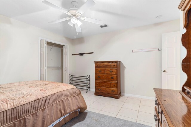 bedroom with ceiling fan, a closet, and light tile patterned floors