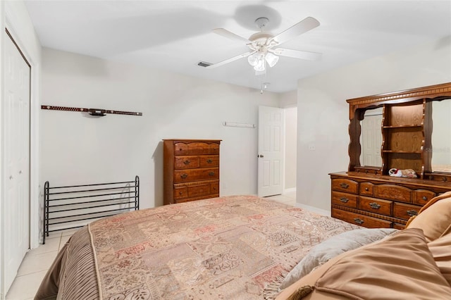 bedroom featuring light tile patterned flooring, ceiling fan, and a closet