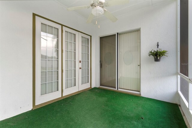 spare room featuring dark colored carpet and ceiling fan