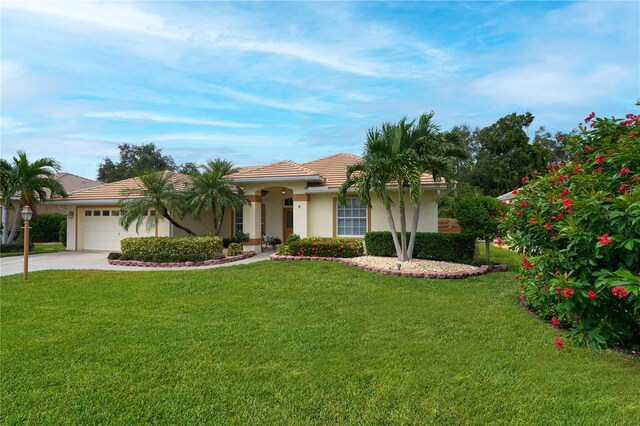 view of front of property with a garage and a front yard