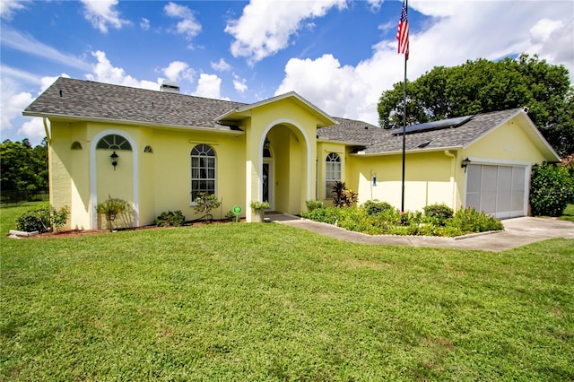 view of front of house featuring a garage and a front yard