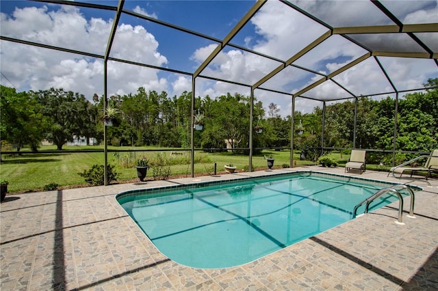 view of pool featuring glass enclosure, a lawn, and a patio