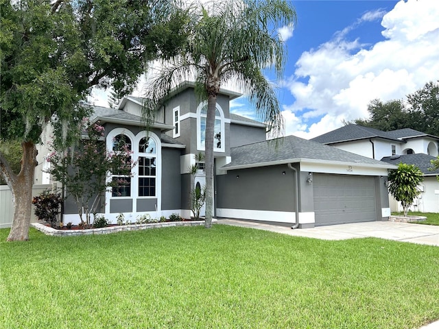 view of front of home with a front lawn and a garage