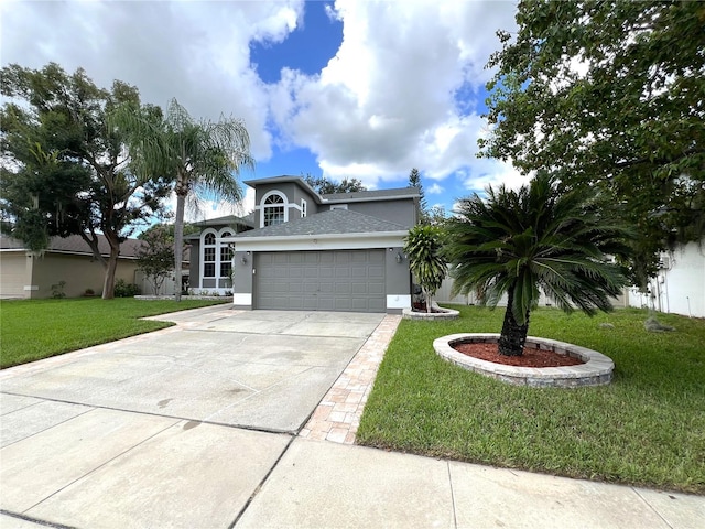 view of front of house featuring a garage and a front lawn