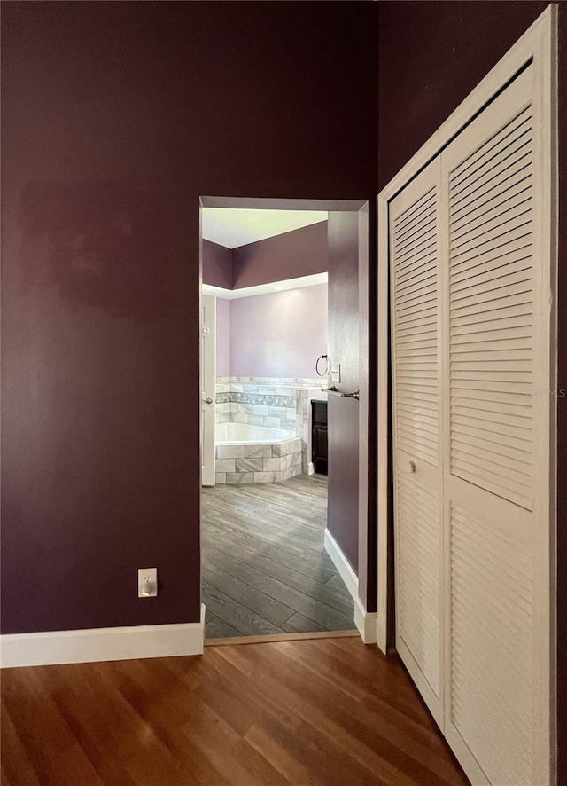 corridor featuring wood-type flooring