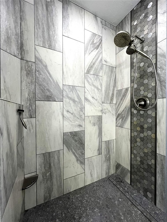 bathroom with tiled shower and ceiling fan