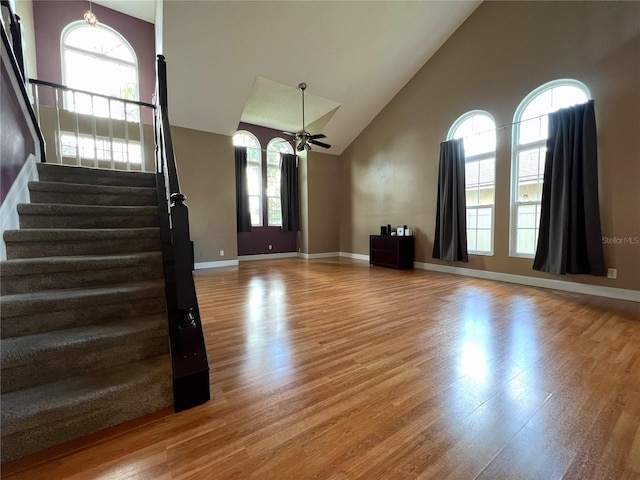 foyer with ceiling fan, light wood-type flooring, and high vaulted ceiling