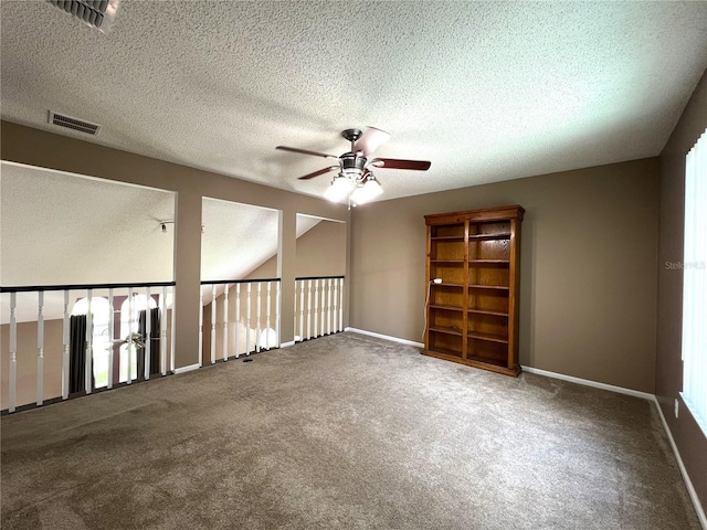 carpeted empty room featuring a textured ceiling and ceiling fan