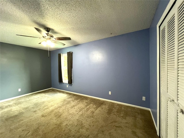 unfurnished bedroom with a closet, ceiling fan, carpet floors, and a textured ceiling