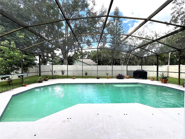 view of swimming pool with a lanai, a patio area, and a grill