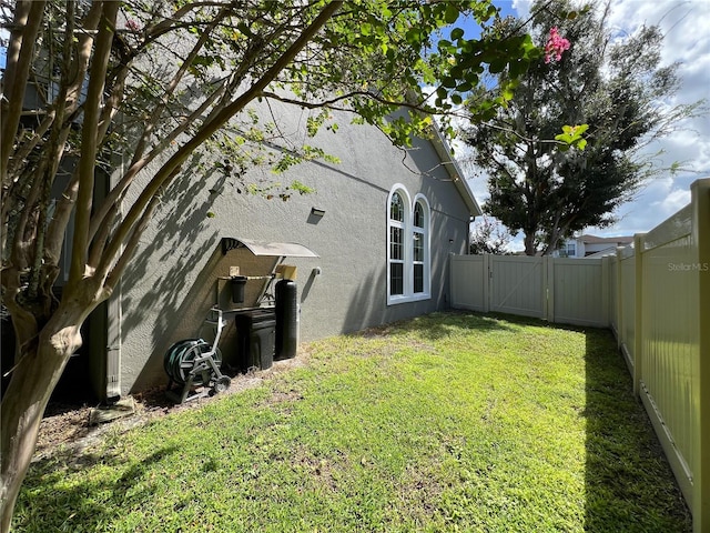 view of side of home with a lawn