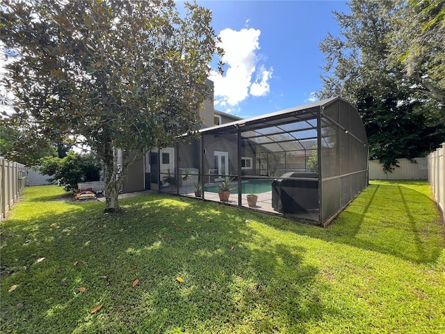 view of yard featuring glass enclosure and a fenced in pool