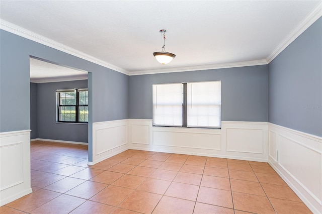 unfurnished room featuring light tile patterned floors and ornamental molding