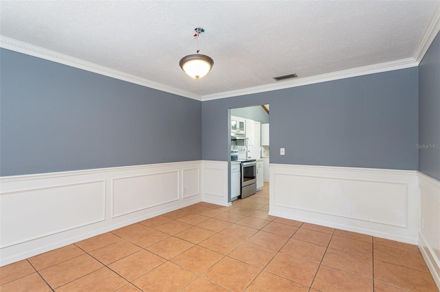 unfurnished room with light tile patterned floors, a textured ceiling, and crown molding