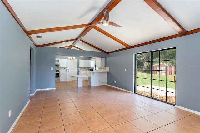 unfurnished living room featuring lofted ceiling with beams, ceiling fan, and light tile patterned floors