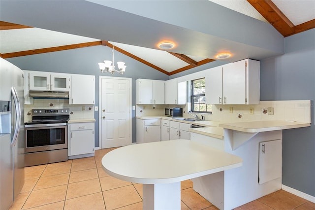 kitchen with stainless steel appliances, lofted ceiling with beams, kitchen peninsula, a breakfast bar, and white cabinets