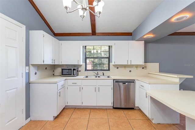 kitchen featuring appliances with stainless steel finishes, white cabinetry, and sink