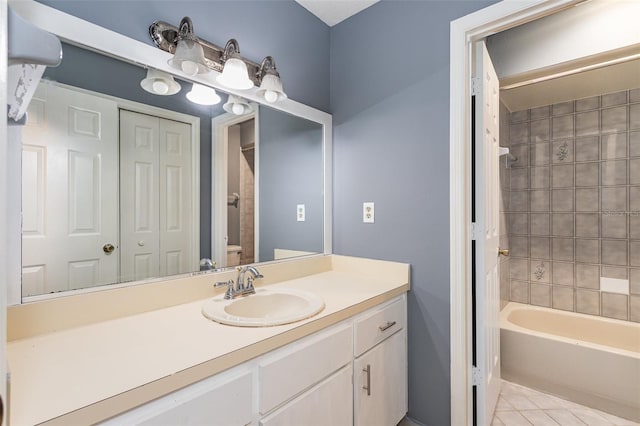 full bathroom featuring tile patterned floors, vanity, toilet, and tiled shower / bath