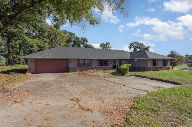 ranch-style house with a front yard, brick siding, a garage, and driveway