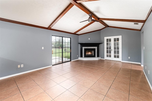 unfurnished living room with light tile patterned floors, a glass covered fireplace, and vaulted ceiling with beams