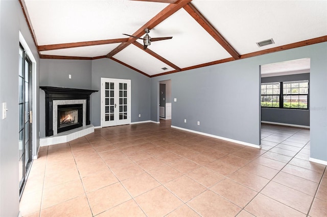 unfurnished living room with visible vents, vaulted ceiling with beams, baseboards, ceiling fan, and a warm lit fireplace