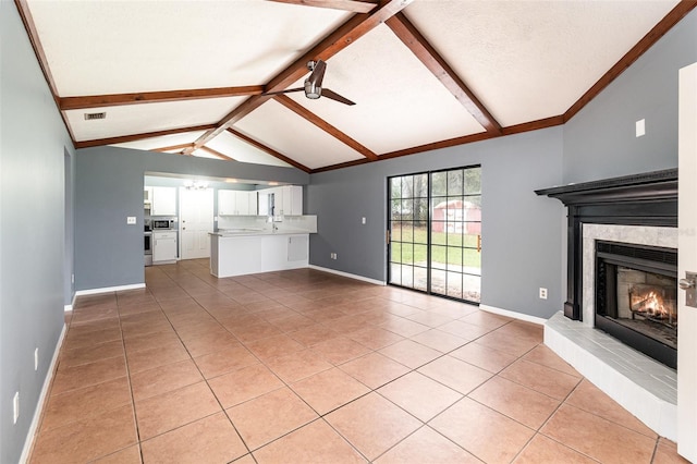 unfurnished living room featuring visible vents, vaulted ceiling with beams, baseboards, a glass covered fireplace, and a ceiling fan