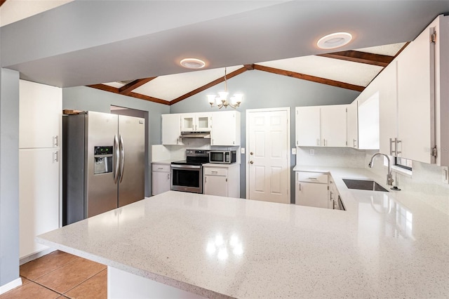 kitchen featuring a sink, appliances with stainless steel finishes, a peninsula, a chandelier, and vaulted ceiling with beams