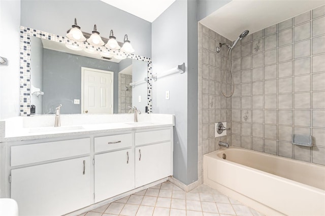 bathroom with tile patterned floors, double vanity, shower / bathtub combination, and a sink