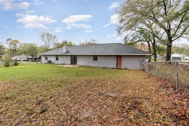 back of property featuring a yard and a fenced backyard