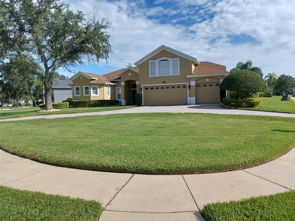 view of front of home with a front lawn and a garage