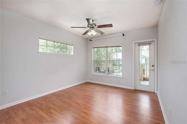 spare room with wood-type flooring and ceiling fan