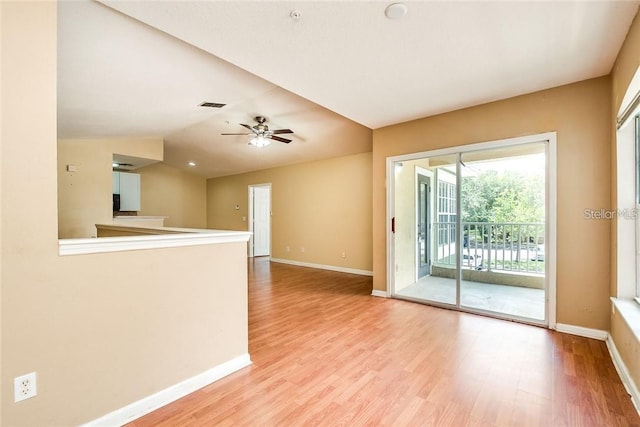 empty room featuring light wood-type flooring, ceiling fan, and lofted ceiling