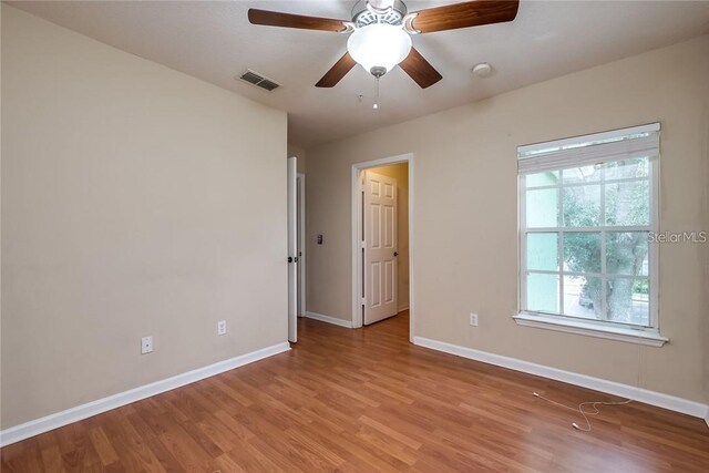 empty room featuring light hardwood / wood-style flooring and ceiling fan