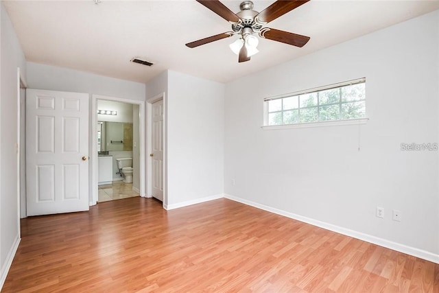 unfurnished bedroom with ensuite bath, ceiling fan, and light hardwood / wood-style floors