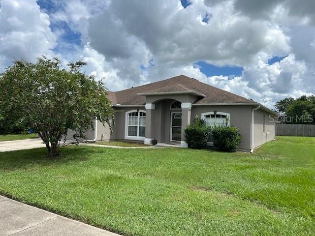 ranch-style home with a front lawn