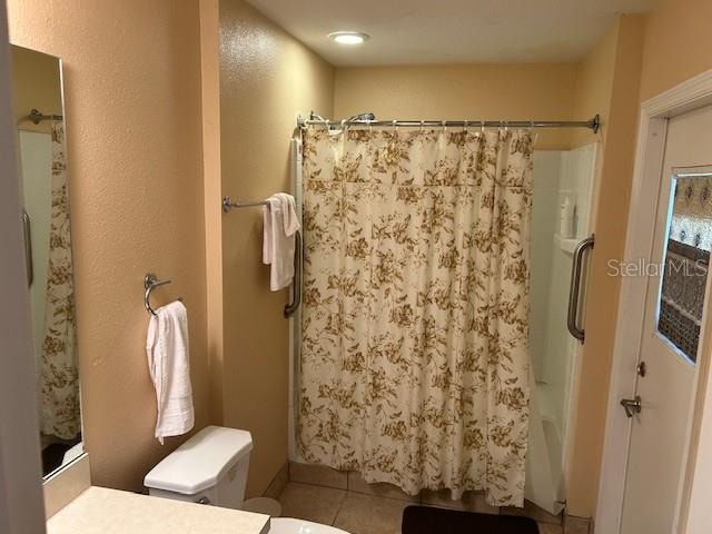 bathroom featuring vanity, tile patterned floors, and shower / bathtub combination with curtain