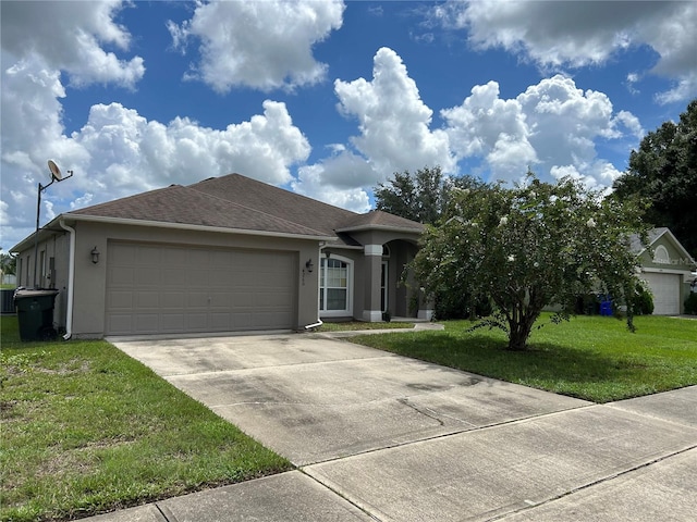 view of front of home featuring a garage and a front lawn