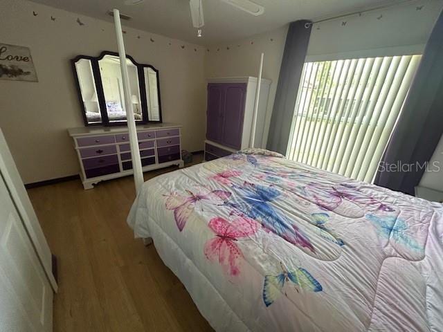 bedroom with ceiling fan and hardwood / wood-style floors