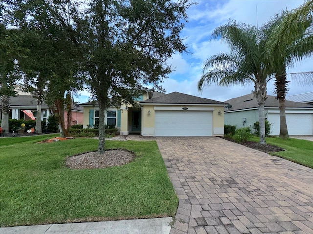 single story home featuring a garage and a front lawn